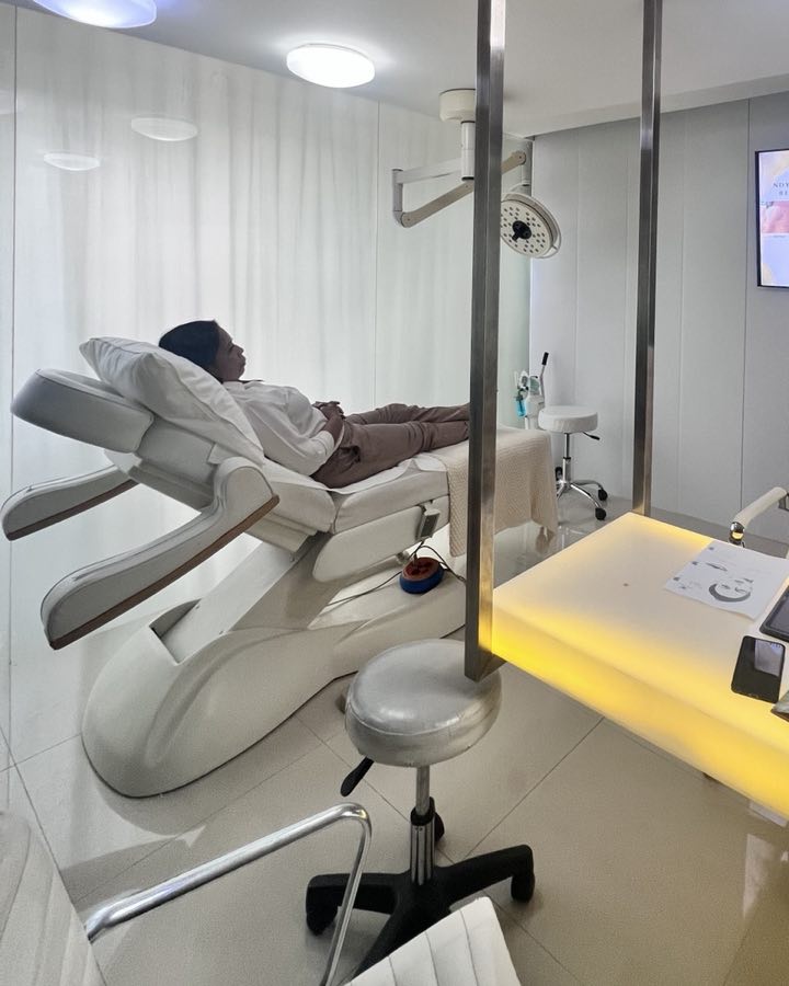 A Cocoon treatment room: a guest resting on the bed beside the lit desk