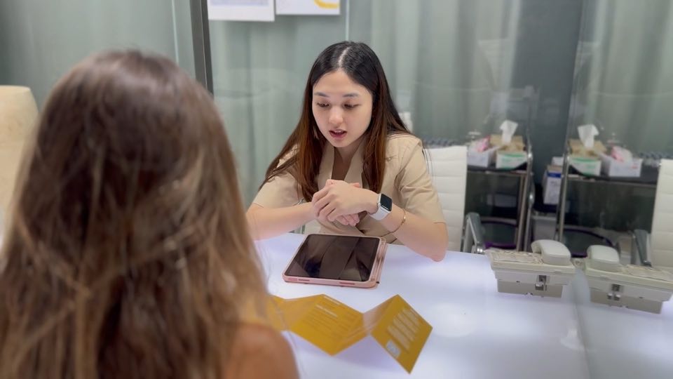 A Cocoon doctor talking a guest through her options across the consultation desk