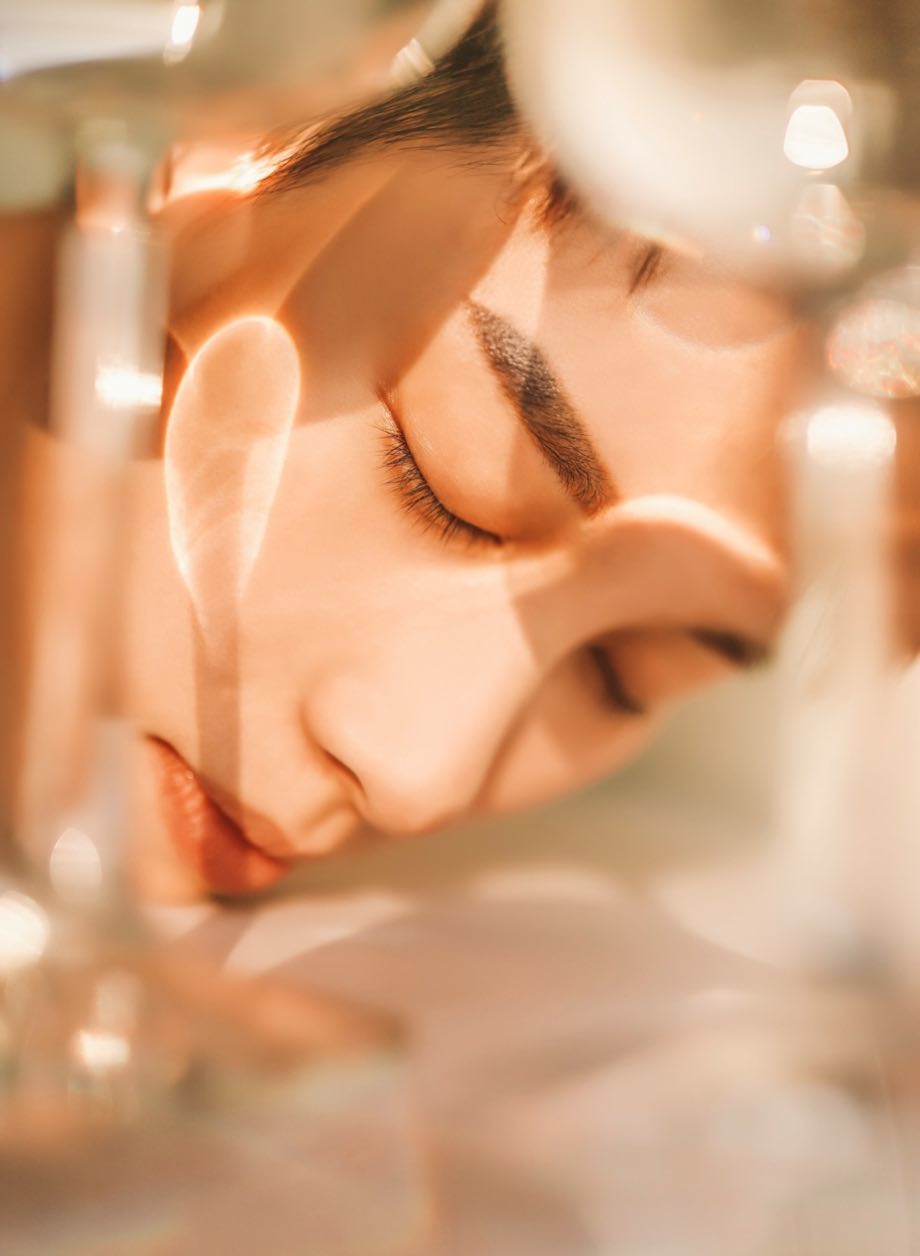 Woman resting with eyes closed in warm golden light