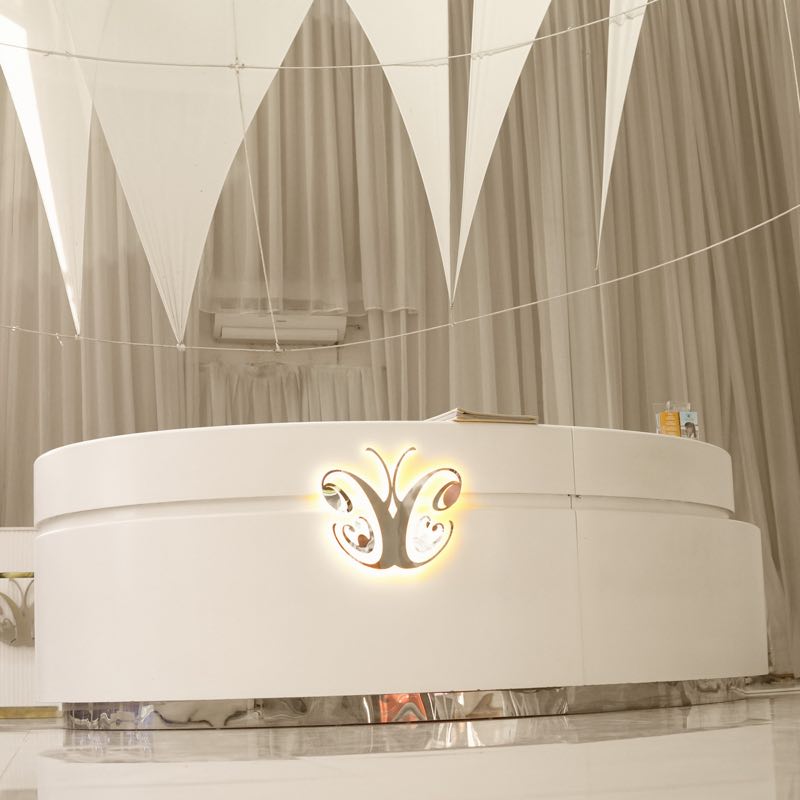 The Legian reception desk with its butterfly logo lit gold