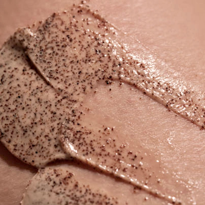 Close-up of a coarse exfoliating scrub spread over skin